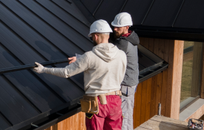 full-shot-roofers-working-together-with-helmets-1-1-e1700044239378